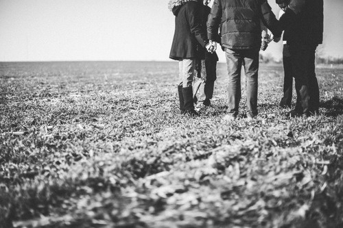 Inspiring gratitude holding hands in field