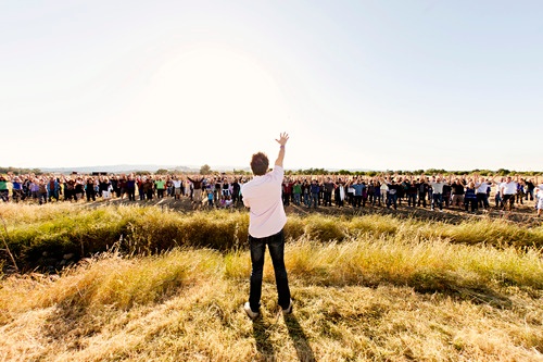 Church Leader in Front of Large Crowd in Field